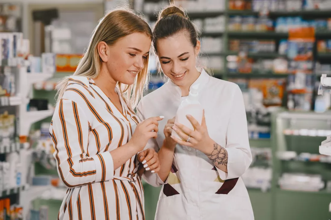 A pharmacist advising a young customer